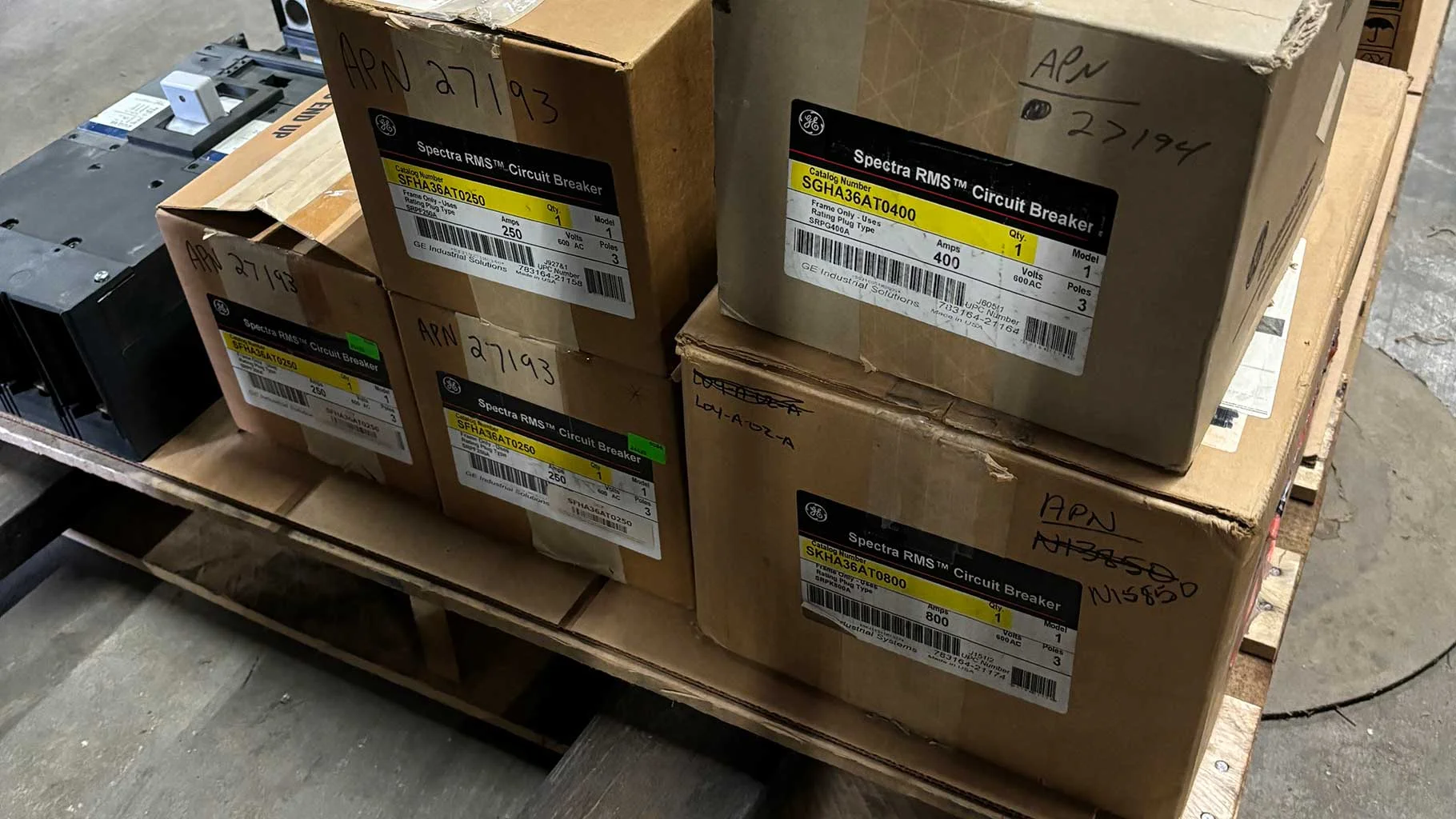 Equipment Pallet Boxes of GE Spectra RMS circuit breakers stacked on a pallet