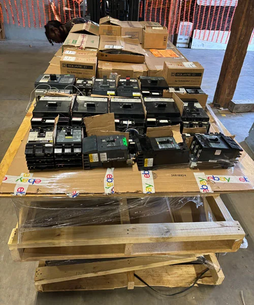Buy Electrical Equipment Wooden pallet stacked with various electrical circuit breakers and boxes, some labeled 'Square D' and 'Schneider Electric', wrapped with eBay branded tape.