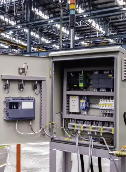 Industrial Control Panel Detail for Systems Utilizing Electrical Transformers for Sale Open gray industrial electrical control panel with PLC, circuit breakers, and terminal blocks.