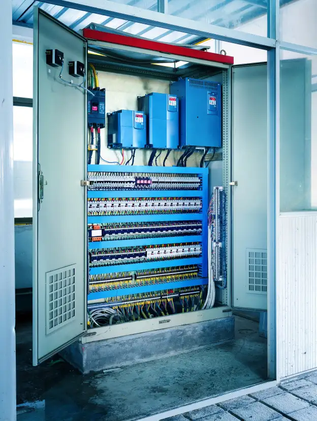 Industrial Switchgear Cabinet: Buyers for Used Electrical Transformers and Surplus Power Equipment. Industrial electrical control panel with VFDs and complex wiring, illustrating switchgear equipment.