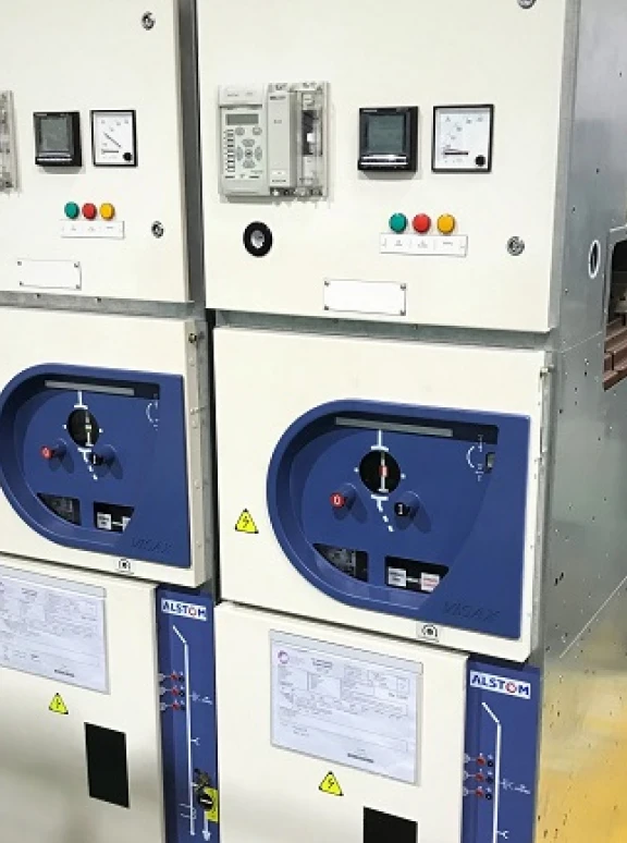 Alstom Gas-Insulated Switchgear Control Panels White and blue industrial electrical switchgear panels with meters, control knobs, and Alstom branding.